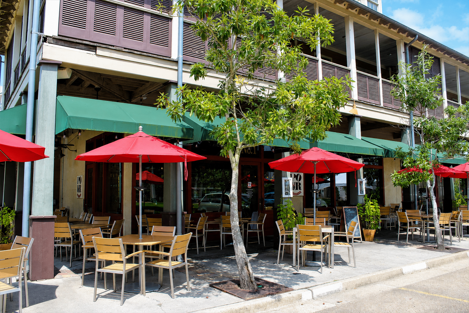POUR's patio with red umbrellas in downtown Lafayette